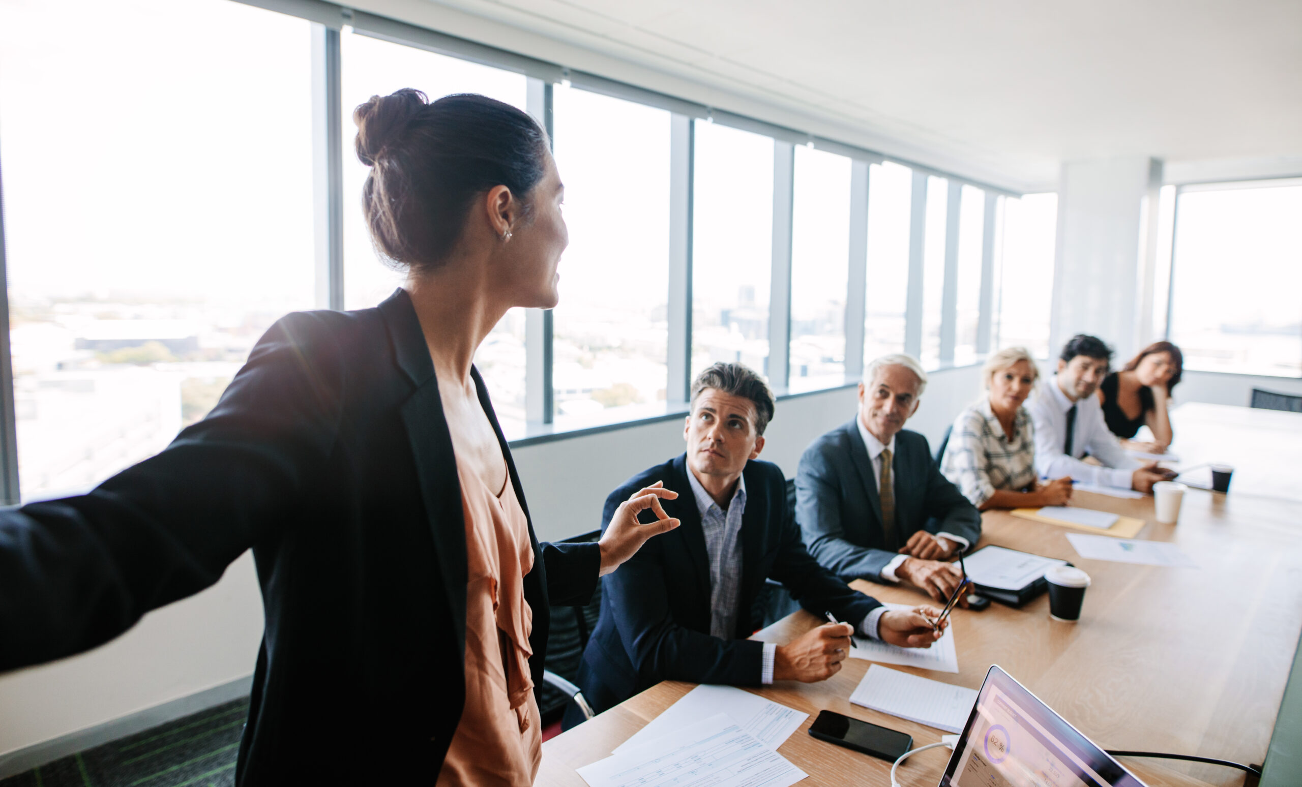 woman presenting at boardroom table