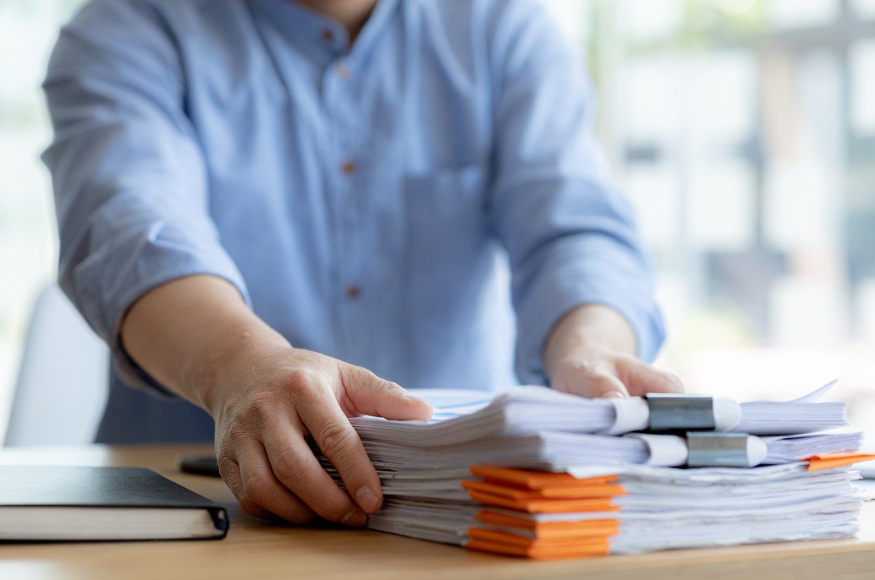 man at desk organising paperwork