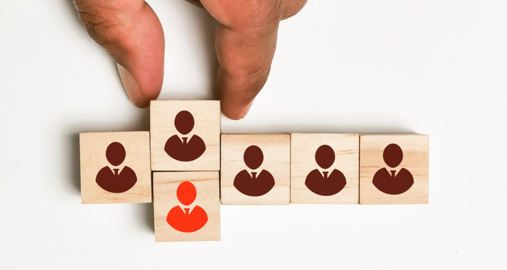 wooden blocks representing hire or fire decision in business