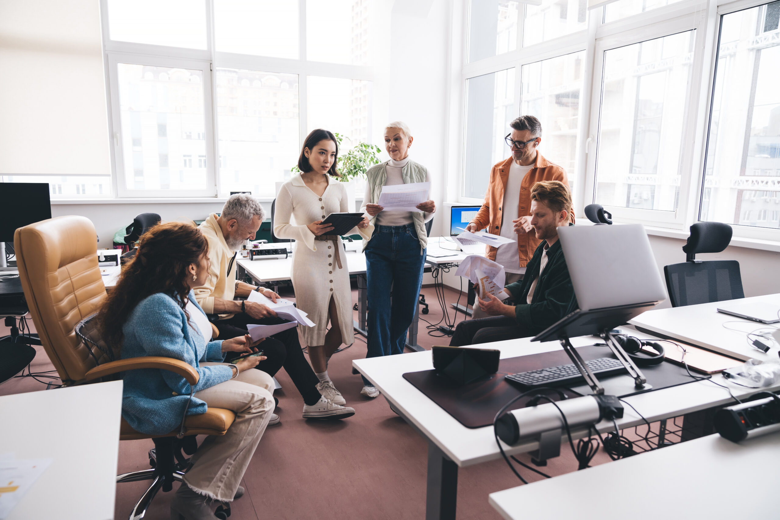 group of coworkers in office setting in productive meeting