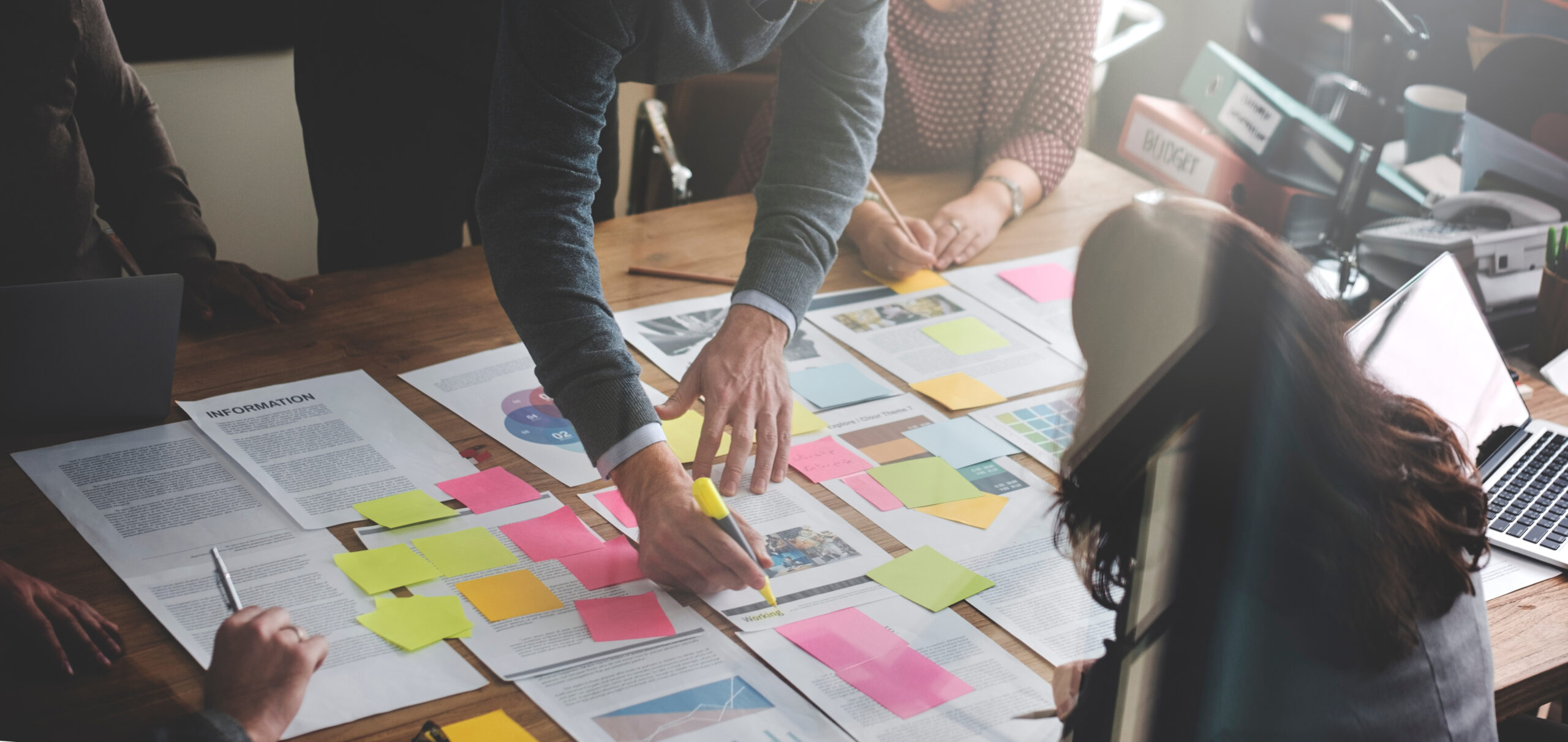 business team pointing at documents on table, working on business plan