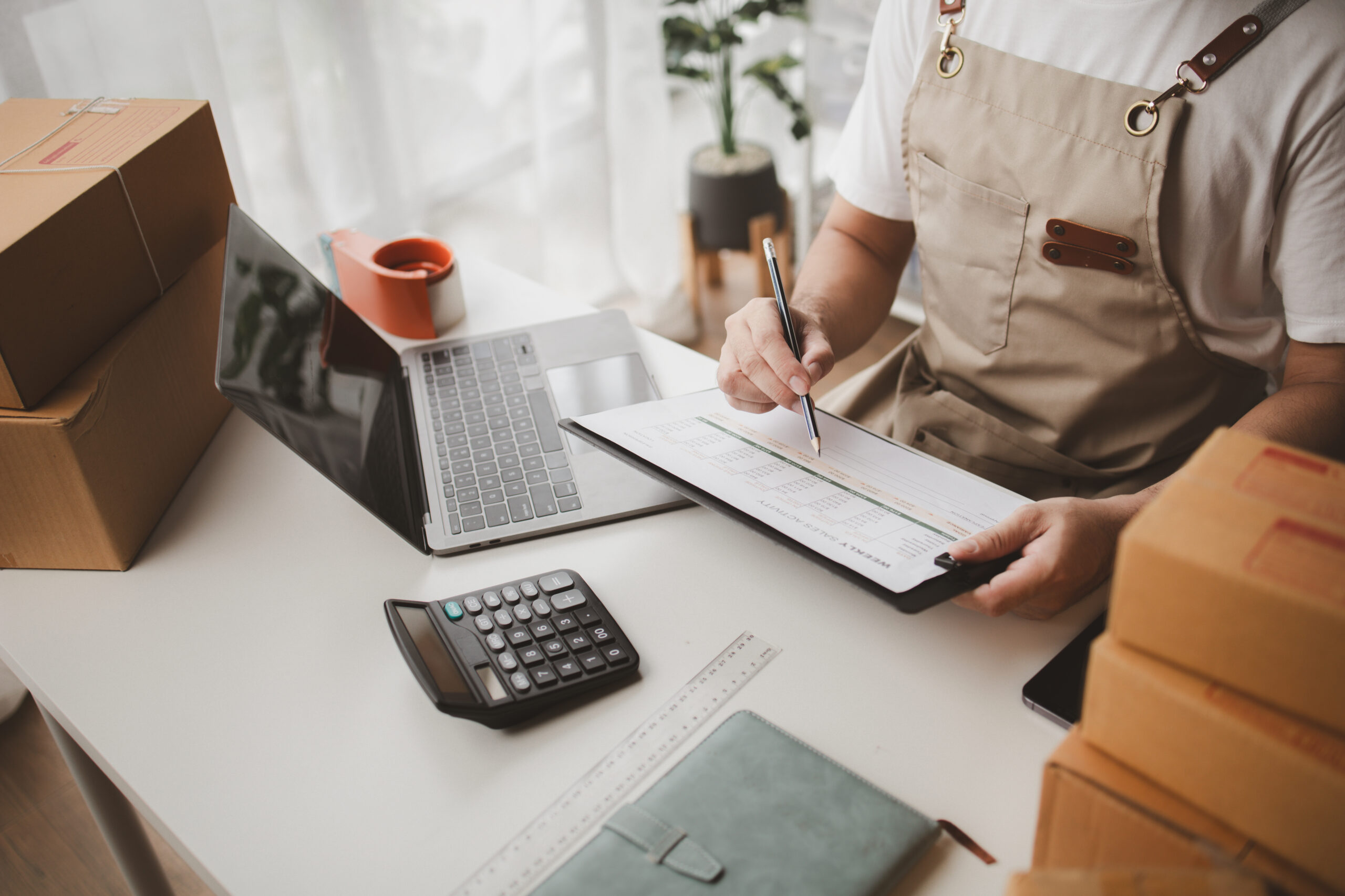 retailer working on business calculations at desk